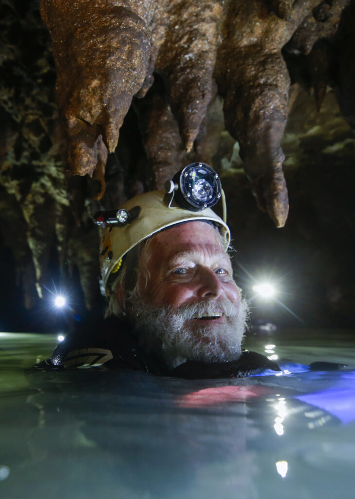 bill steele up to his neck in a water cave